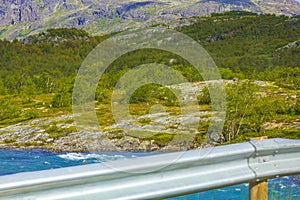 Turquoise blue water of fjord river behind guardrail landscape Norway