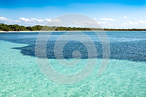 Turquoise clear water near beach. Deep blue waters of the Caribbean Sea meet a bay on the island of Isla de la Juventud, Cuba