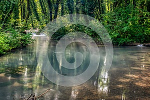 Turquoise color of water in the summer on the river Janj