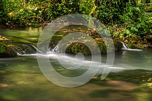 Turquoise color of water in the summer on the river Janj