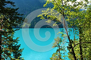 Turquoise colored surface of Weissensee lake in Carinthia, Austria