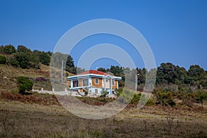 Turquoise colored two storey house in the distance view