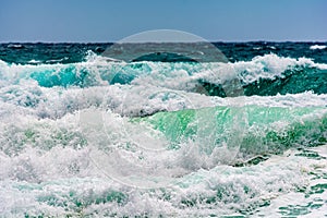 Turquoise colour ocean wave in windy day