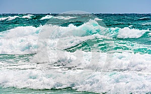 Turquoise colour ocean wave in windy day
