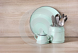 Turquoise crockery, tableware, dishware utensils and stuff on wooden table-top. Kitchen still life as background for design.