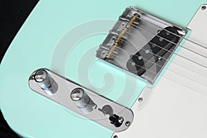 Turquoise electric guitar bridge, pickups, volume and tone controls