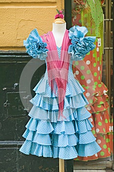 Turquoise flamenco dress is displayed in Centro old district of Sevilla Spain