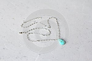 Turquoise in form of drop on silver chain necklace Pendant. Short necklace on girl made of natural stones Turquoise nugget.