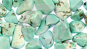 Turquoise heap jewel stones texture on white light background. Moving right seamless loop backdrop