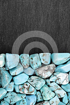 Turquoise heap stones texture on half black stone background. Place for text