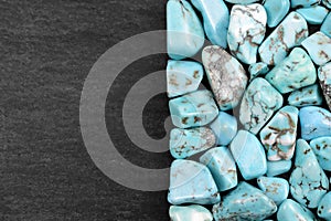 Turquoise heap texture on half black stone background. Place for text