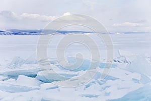 Turquoise ice floe. Ice-drift of Baikal lake. Winter landscape.