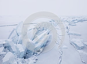 Turquoise ice floe. Ice-drift of Baikal lake. Winter landscape.