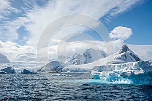 Turquoise icebergs, bright white snow, glaciers and clouds. Pen