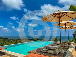 Turquoise infinity pool with incredible view over the ocean