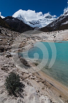 turquoise lagoon of paron with pyramid mountain in the background covered with ice and snow