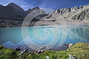Turquoise lake Gradensee at Nossberger Hut with mountains in Gradental in national park Hohe Tauern, Austria