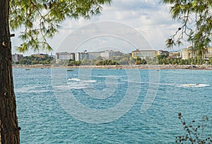 Turquoise mediterranean sea, Turkey. Defocused background with beach and hotels view. Color image and copy space