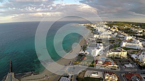 Turquoise Mediterranean sea water washing sandy beach at Cyprus resort city