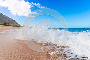 Turquoise ocean wave splash on tropical sandy beach