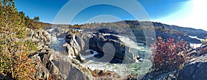 Turquoise rapid mountain river flows among high rocks. Autumn landscape of a wide mountain river on a sunny day