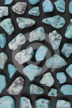Turquoise rare stones texture on black stone background