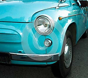 Turquoise retro car close up view