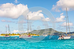 Turquoise sea and anchored yachts at Sandy beach island, near Carriacou island, Grenada, Caribbean sea