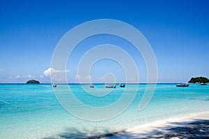 Turquoise sea And blue sky White Sand Beach with taxi long tail
