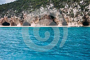 Turquoise sea and caves of Cala Luna beach in Sardinia island