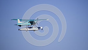 Turquoise sea plane taking off