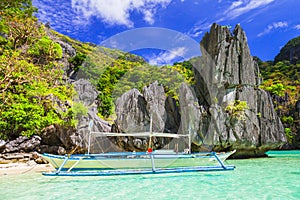 Turquoise sea,unique rocks and traditional boat in El Nido,Palawan,Philippines.