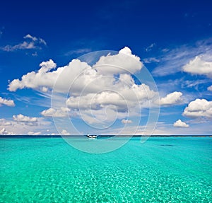 Turquoise sea water and cloudy blue sky. paradise island