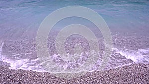 Turquoise sea waves on beach sand, Porto Germeno, Greece, seaside near Athens