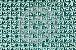 Turquoise stone wall forms grid pattern