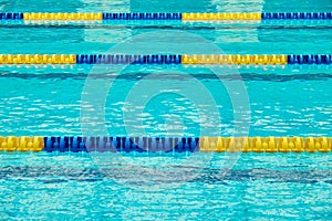 Turquoise swimming pool lanes, a symbol of sport