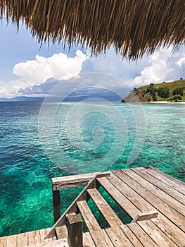 Turquoise transparent clear water view from wooden pier