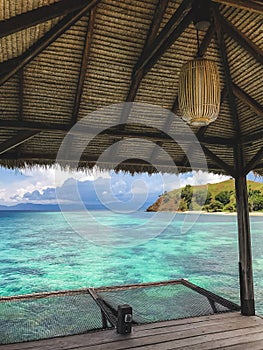 Turquoise transparent clear water view from wooden pier