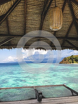 Turquoise transparent clear water view from wooden pier