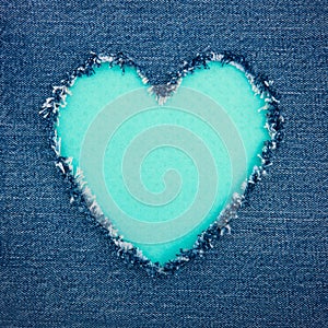 Turquoise vintage heart on blue denim fabric