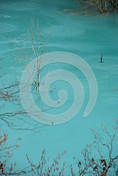 Turquoise waste waters from a copper mine polluting the environment. Decanting lake