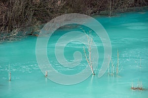Turquoise waste waters from a copper mine polluting the environment. Decanting lake