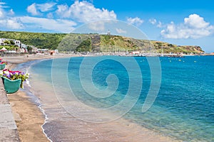 Turquoise water of the bay of Praia da VitÃ³ria with hill with the Facho viewpoint in Porto Martins, Terceira - Azores PORTUGAL photo