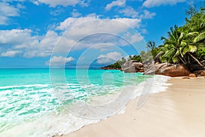 Turquoise water, granite rocks and palm trees in Anse Lazio