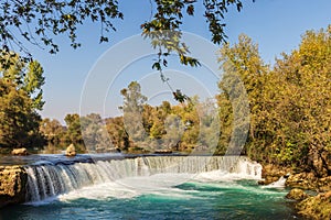 Turquoise water of Manavgat River flowing over the Manavgat Waterfall.
