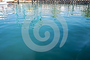 Turquoise water surface in the harbor.