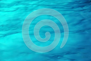 Turquoise water surface texture sunlight with a sun light