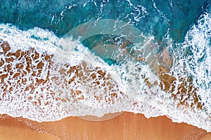 Turquoise water with wave with sand beach background from aerial top view. Concept summer sunny travel image