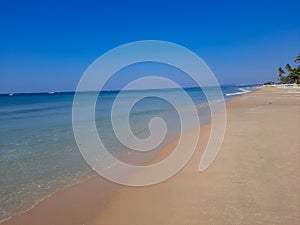 Turquoise water and white sand in beautiful Colva beach, clean water Arabian sea beach, goa beach, tropical beach.