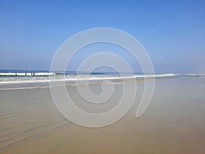 Turquoise water and white sand in beautiful Colva beach, clean water Arabian sea beach, goa beach, tropical beach.